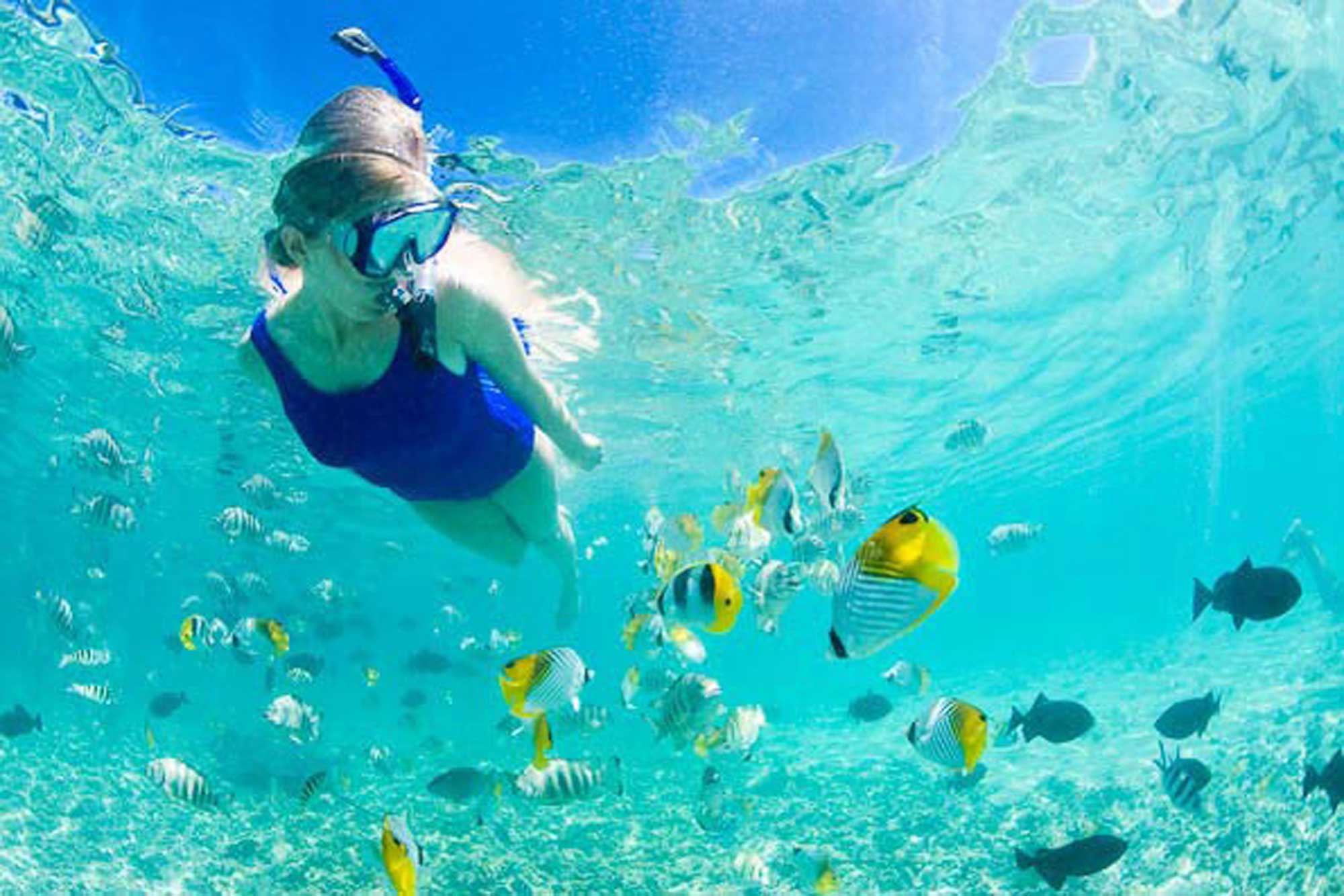 female swimming under water