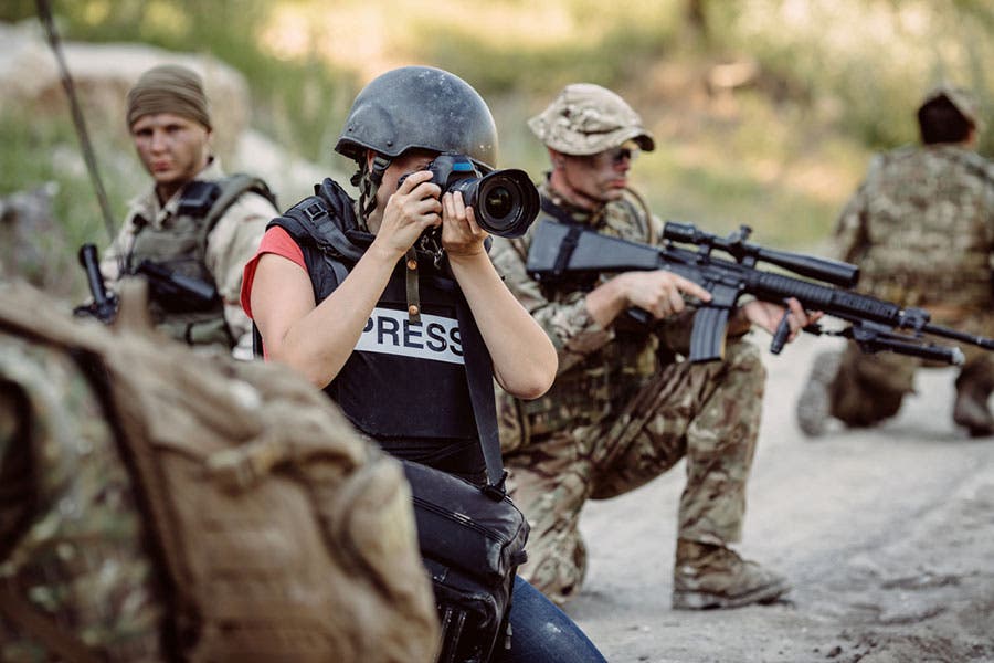 photojournalist holding a dslr camera