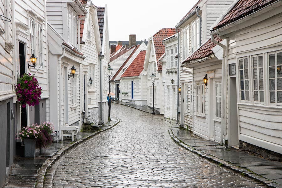 Curvy street with old white houses