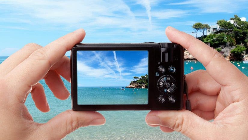 hands holding digital camera