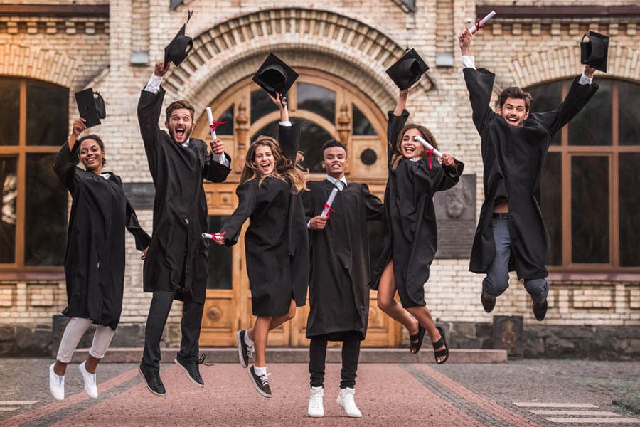 Student graduates are holding diplomas and happy while jumping