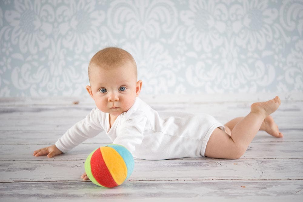 baby posing on floor drop background