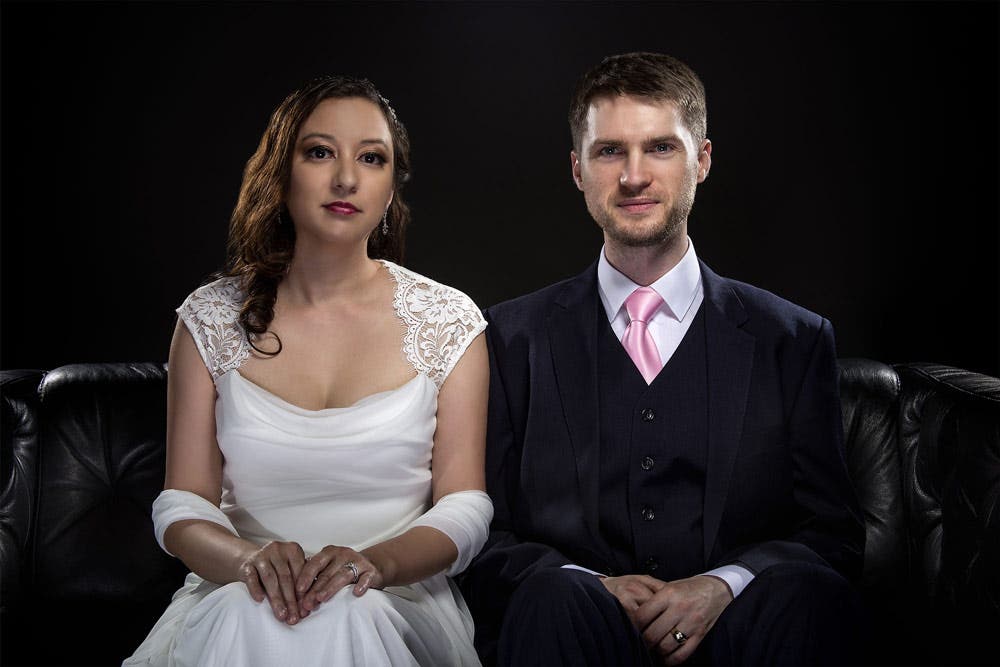 bride and groom in front of velour fabric photography backdrop