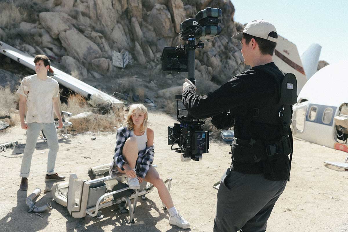 filmmaker directing actors with a camera and stabilizer