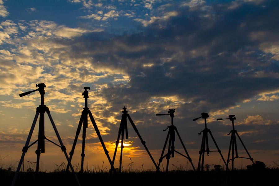 Tripod Silhouette many lined up the sun in the countryside