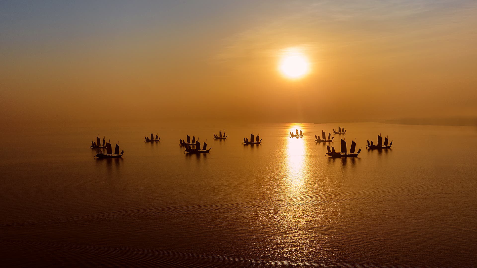 Traditional Chinese junks at sunrise, Huzhou, China.