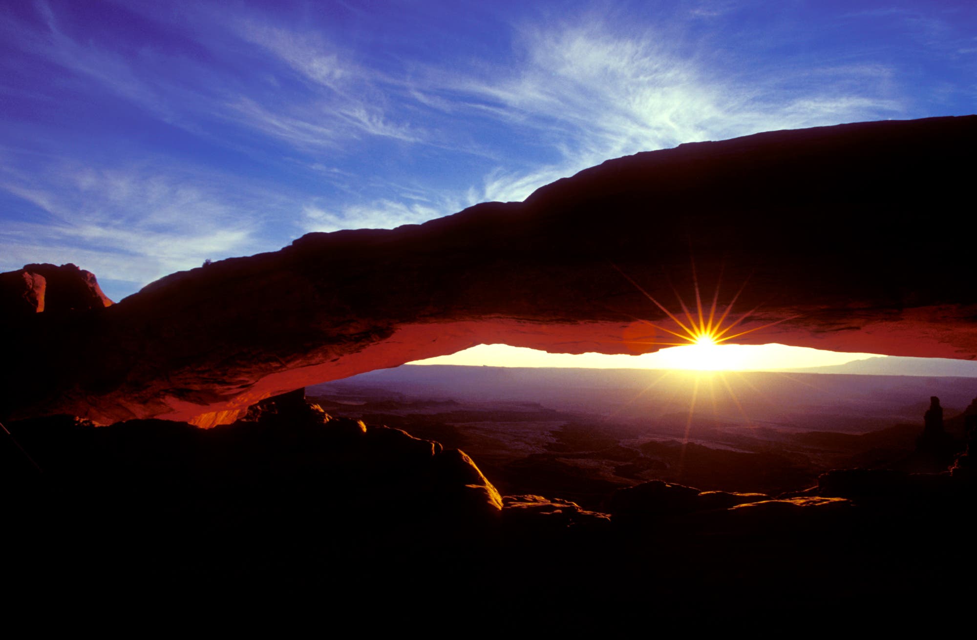 I bring students to Mesa Arch before dawn so they are all set for getting spectacular shots of this iconic location in Arches National Park. I took a series of pictures, including this one at the moment when the sun was partly hidden by arch and washing the surrounding in rich color. I was able to maintain sharpness and create the star effect by stopping down to f/32 and checking through the viewfinder using my preview button.