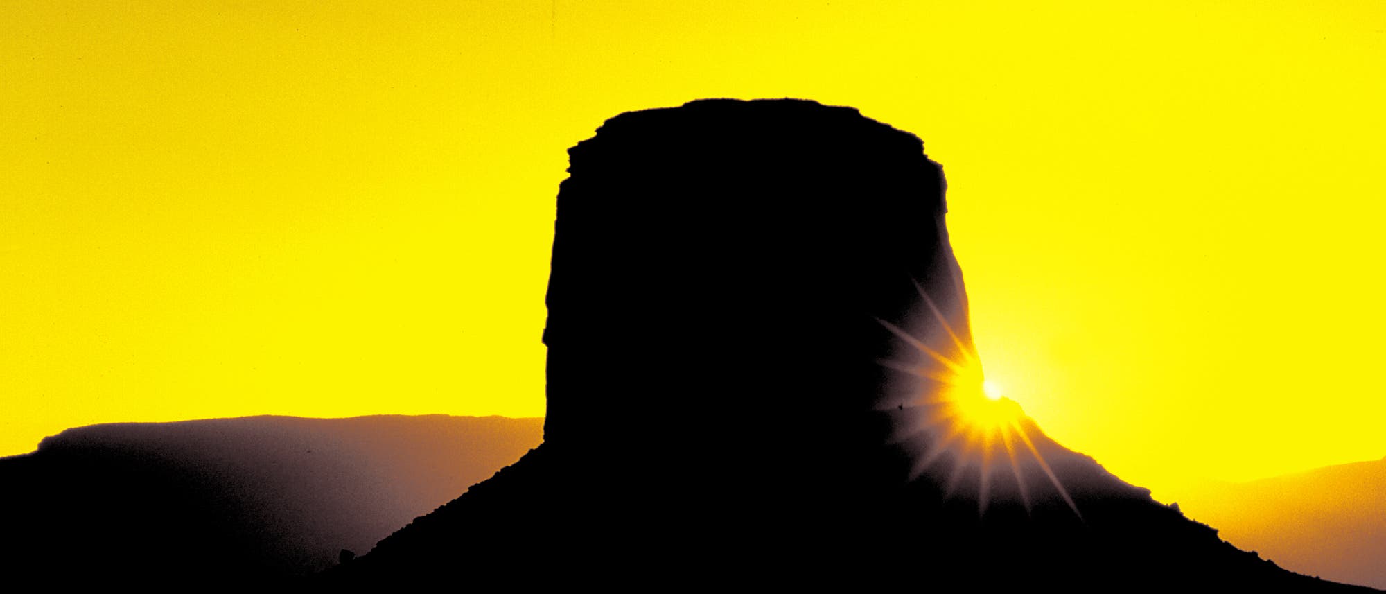 For a dramatic star effect in this image taken in Monument Valley, I arrived before sunrise and positioned myself facing the sun with my camera on a tripod. Using my 300mm lens and a small aperture (f/22), I began shooting as soon as the sun came up. (You should be able to see this star effect using your camera’s preview button.) The long lens concentrated the yellow color of the sunlight at dawn.