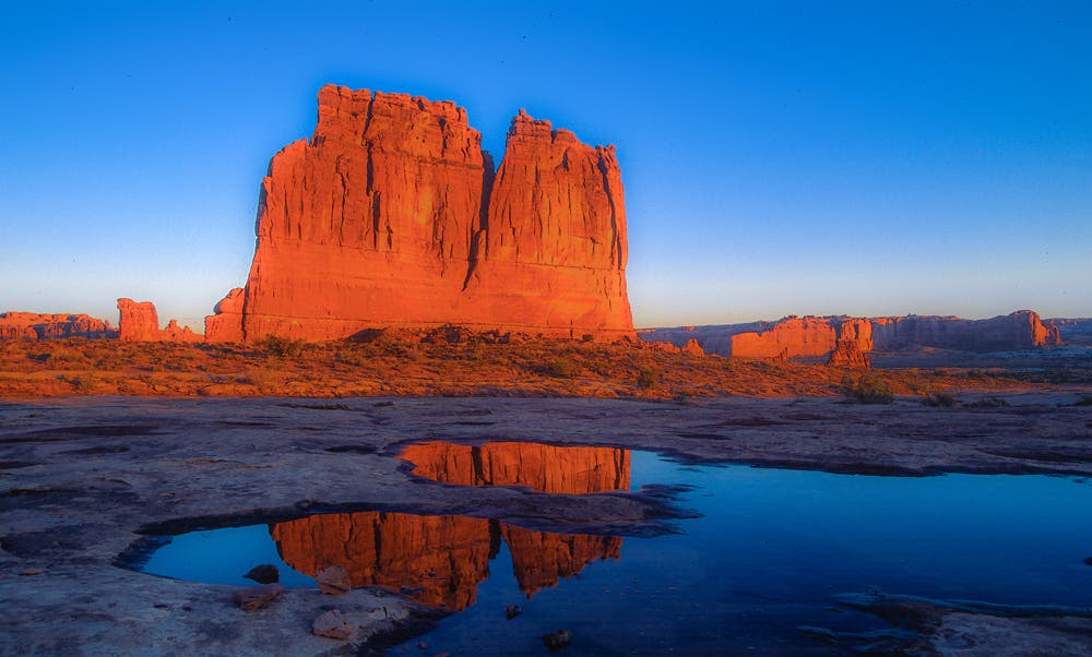 The West is dotted with geologic formations like this butte. Capture these iconic forms when the light makes them glow. In this shot, I wanted to go beyond the norm so I came back in the morning after a downpour and shot the same butte reflected in a nearby puddle. To get this shot, I got down low, focused on the reflection and used f/16 for maximum sharpness.