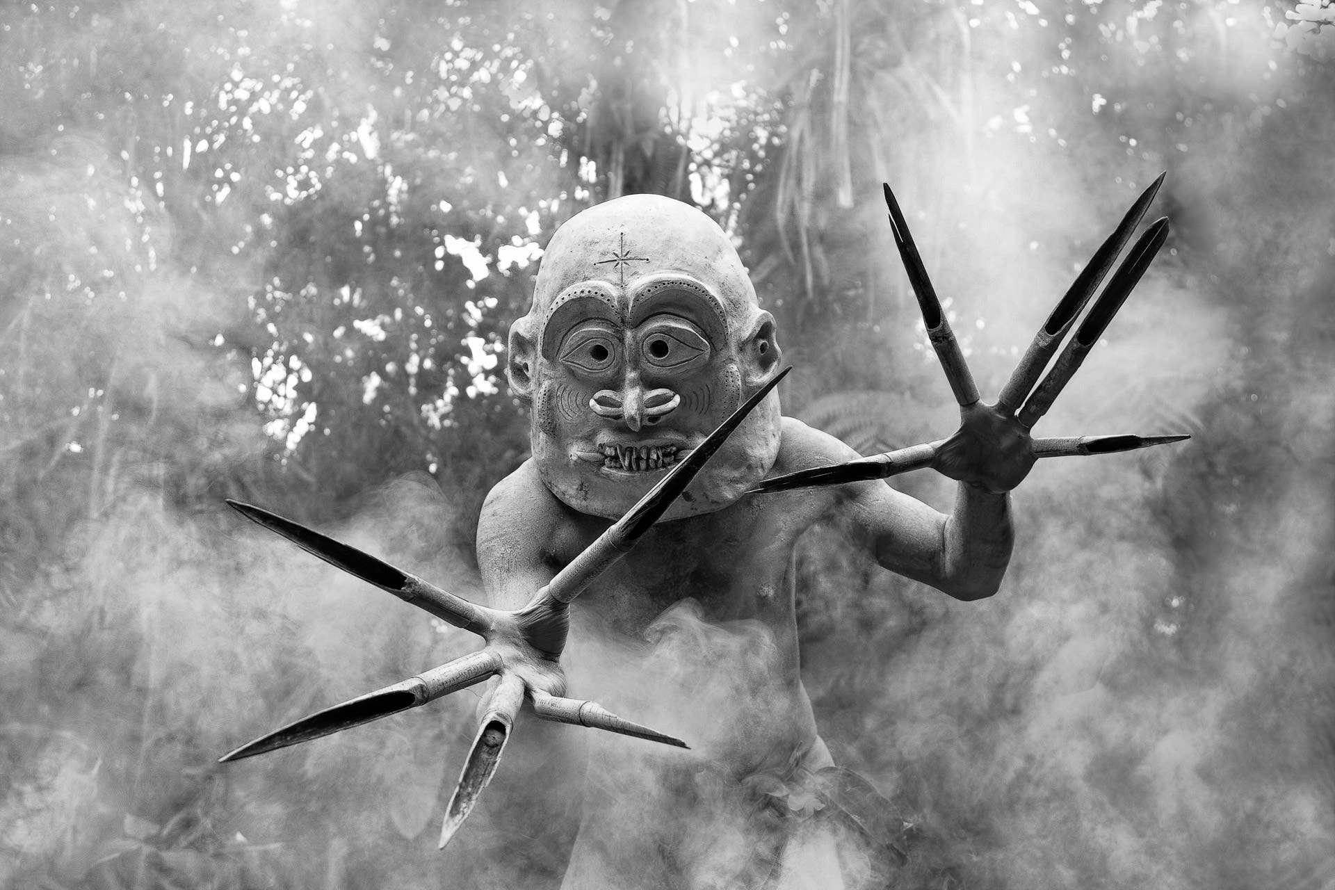 The feared mudmen of Pogla Village. Papua New Guinea. These warriors dress as the spirits and creep through the mist and jungle to scare away enemies that are stronger and may have otherwise defeated them. The sight of these men as they move and the sound they make when they "click clack" their "fingers" open and shut is very eerie!