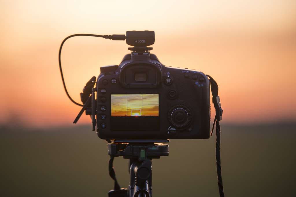 DSLR camera shooting video of sunset