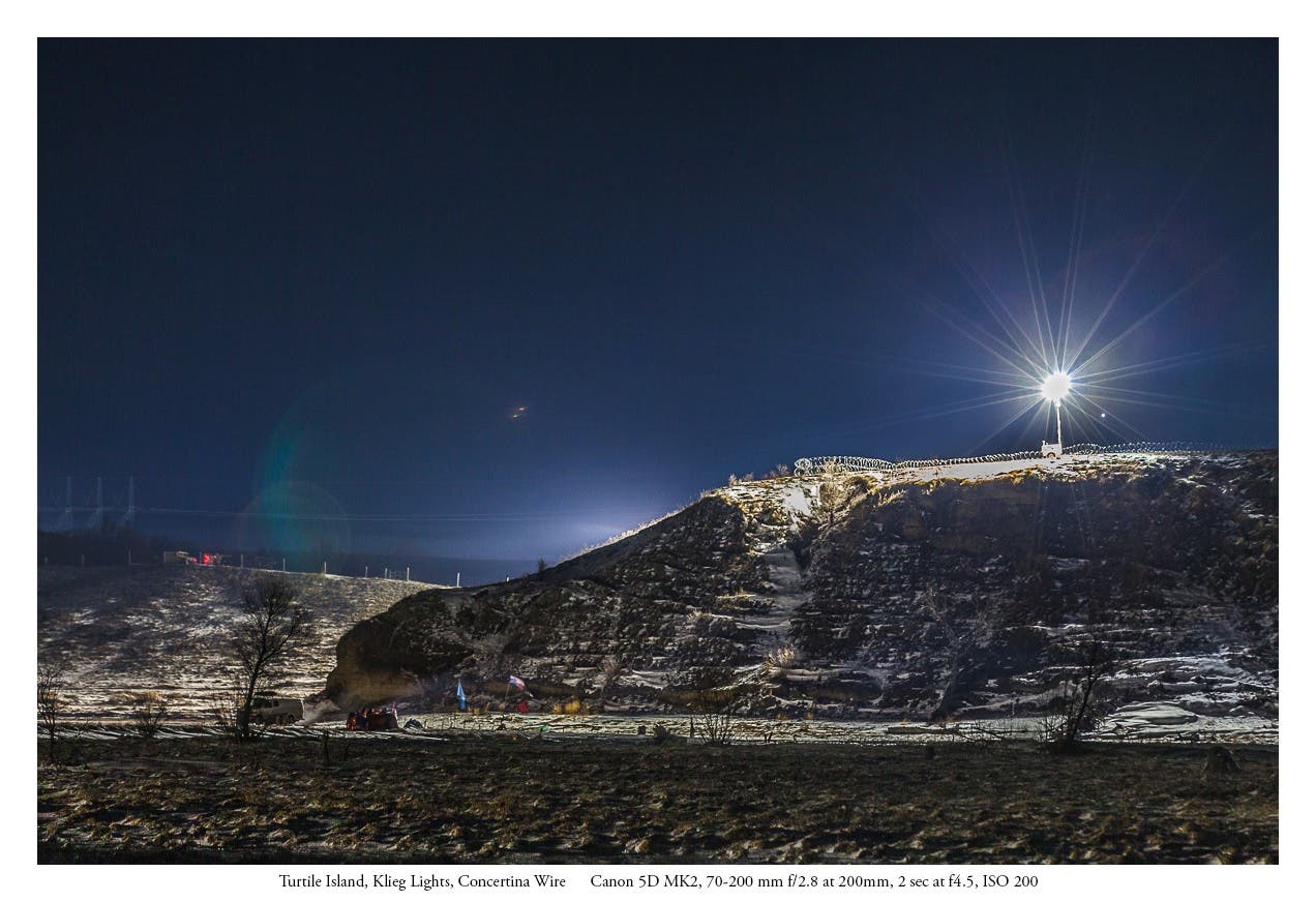 Turtle Island burial ground under Klieg Lights and wrapped in Concertina Wire.