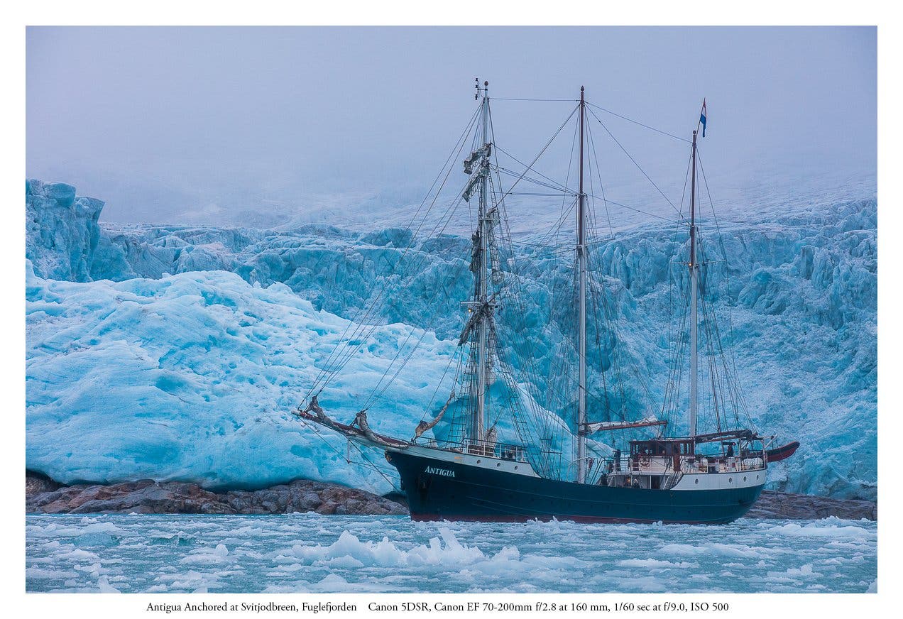 The scale of the Svitjobreen glacier is made visible here in relation to the boat which is anchored a good three hundred yars or so from the glacier's 60 meter hight face. (Canon 5DSR Canon EF 70-200 at 160 mm) 1/60 sec at f/9.0. ISO 500