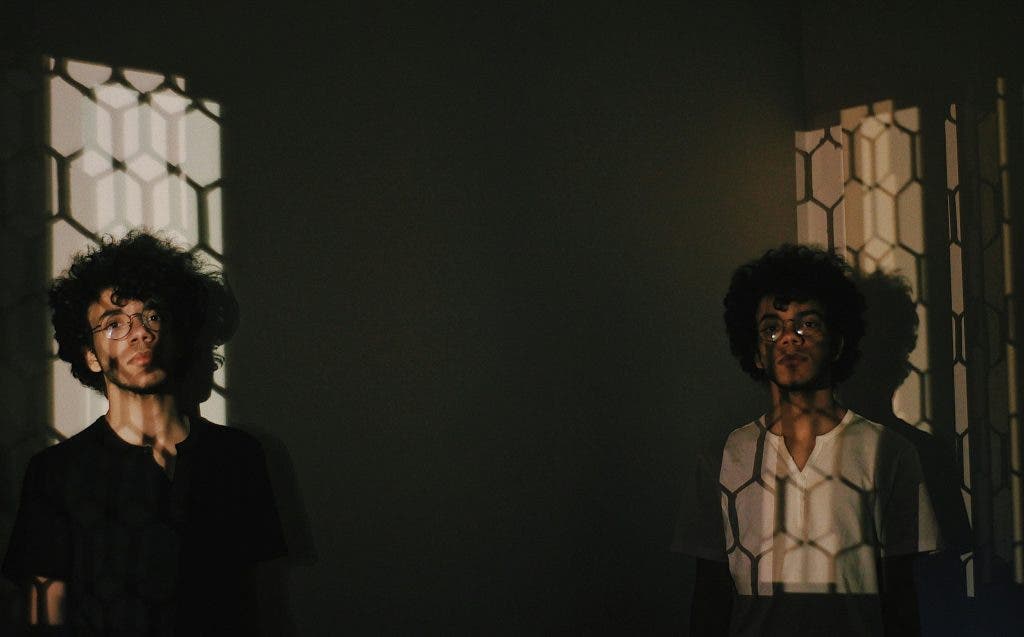 Man stands in front of creative lighting fixture