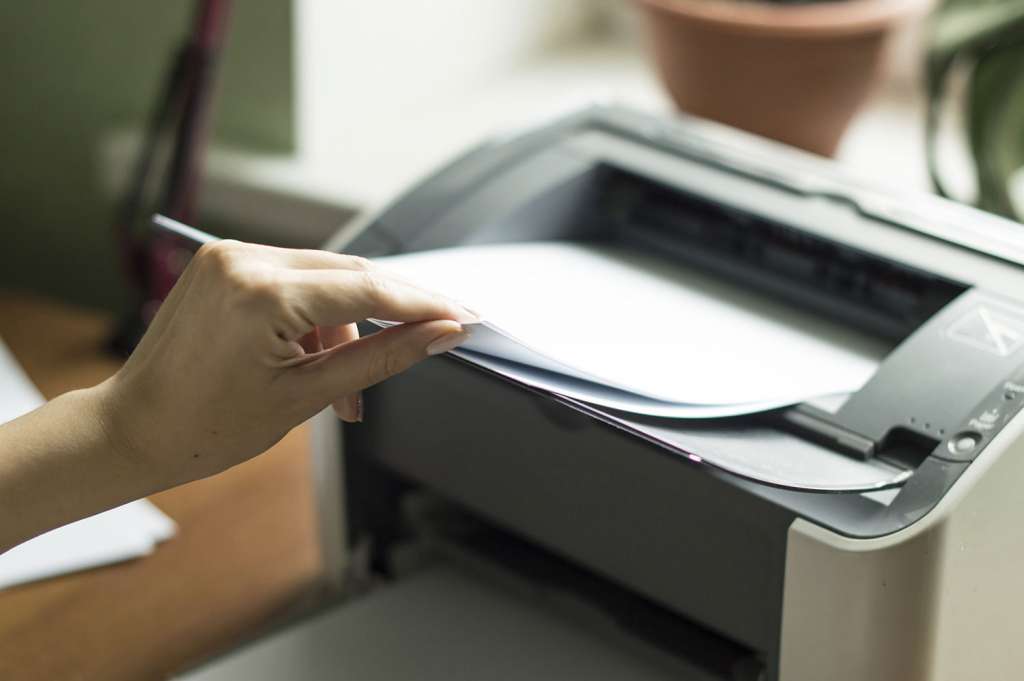 feeding paper into monochrome laser printer