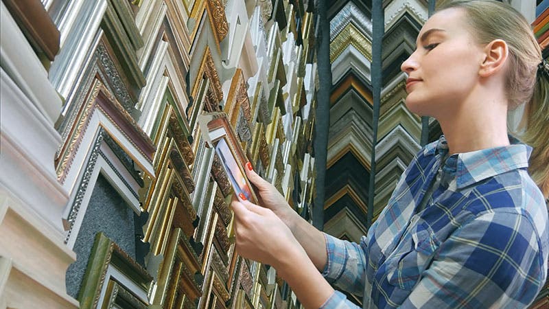 woman picking out photo frames