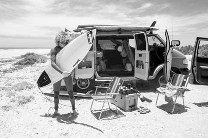 man holding surfboard infrared photography