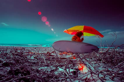 surfer with umbrella at beach infrared photography