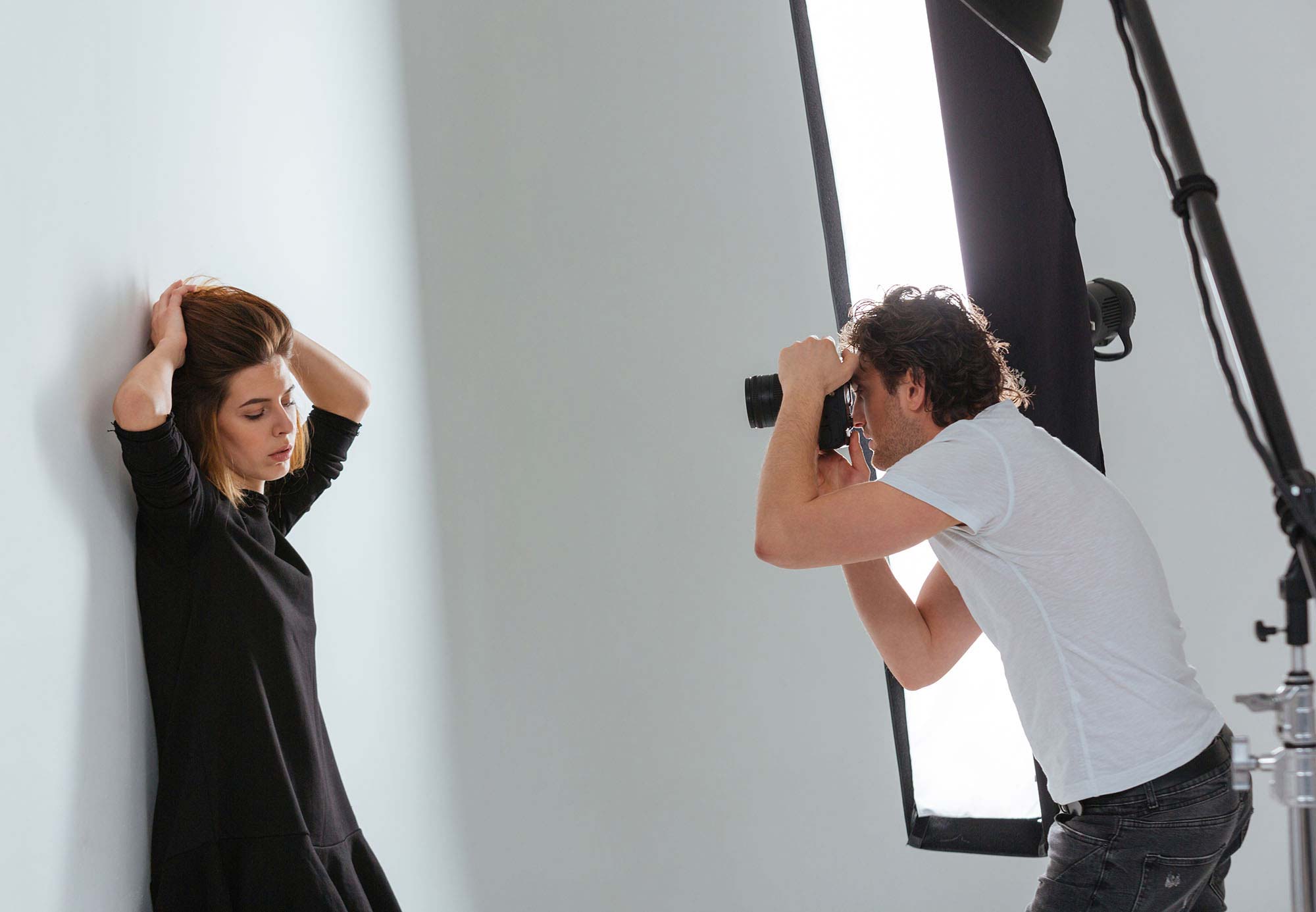 photographer shooting portrait of model in studio