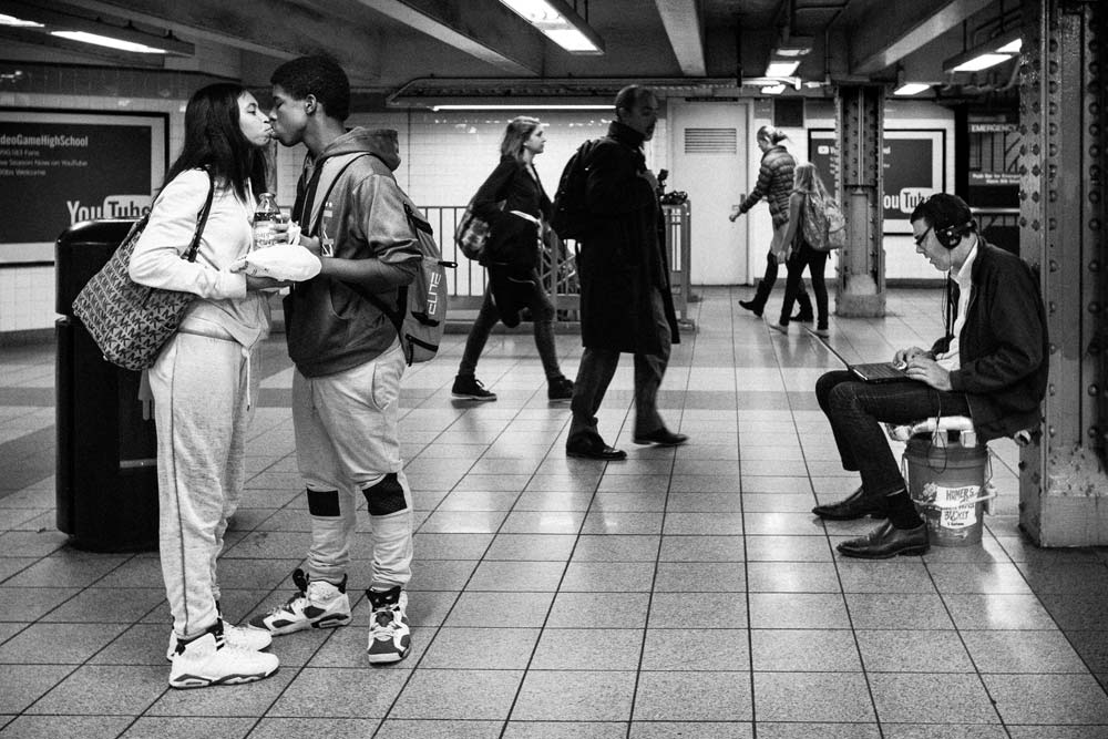 couple kissing in subway street photography