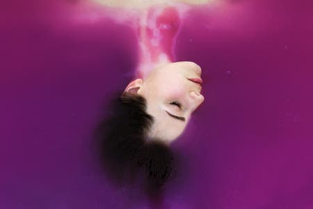 disembodied head against purple background