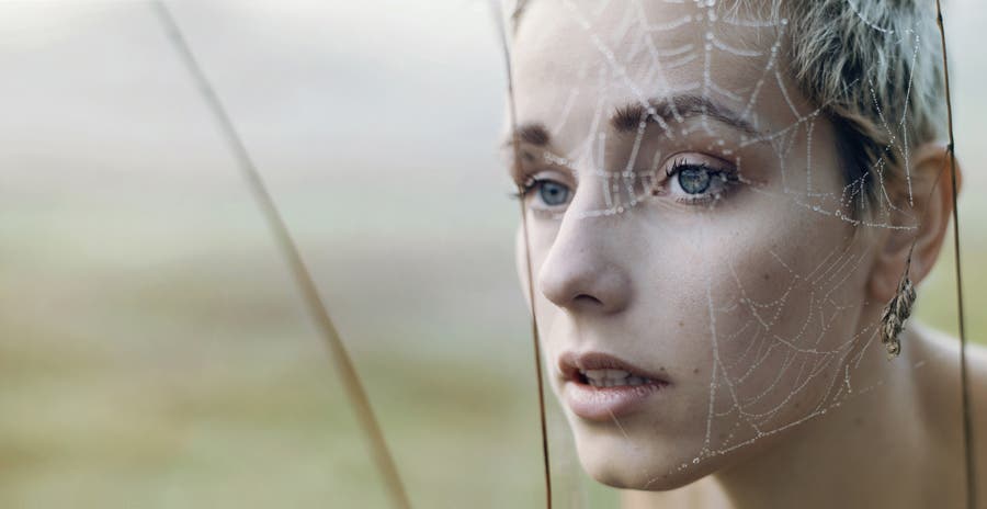 female model covered with spider web