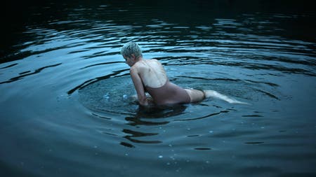 model sitting in water