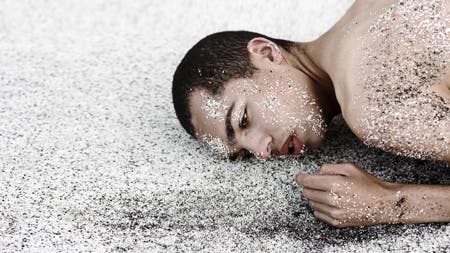 model lying in the sand