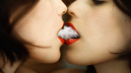 model smoking in front of mirror