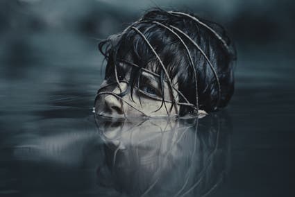 feminine submerged in water