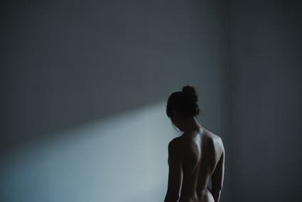 naked feminine in the dark