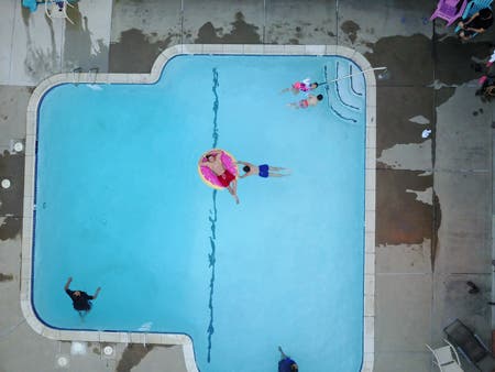 people swimming in pool drone photography