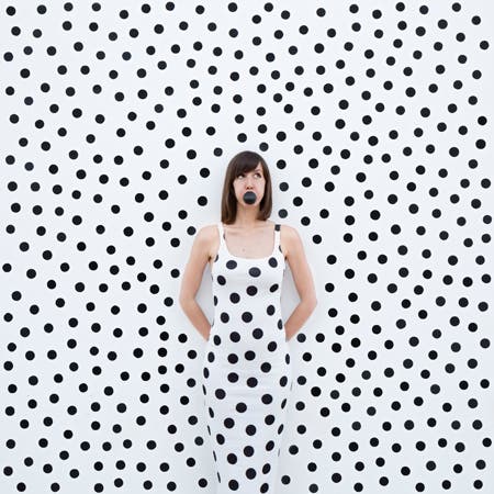 woman in polka dot dress with polka dot background