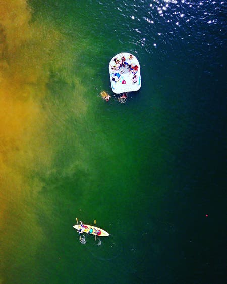 people relaxing in the ocean drone photography
