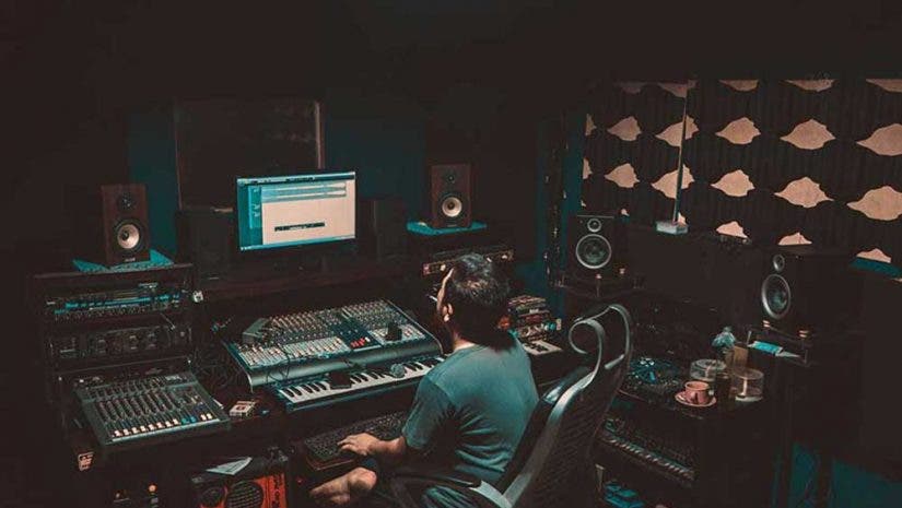 man mixing in his growing home recording studio setup