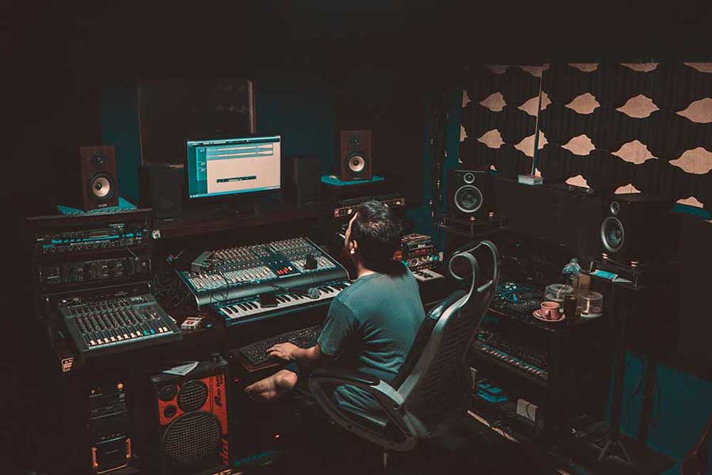 man mixing in his growing home recording studio setup