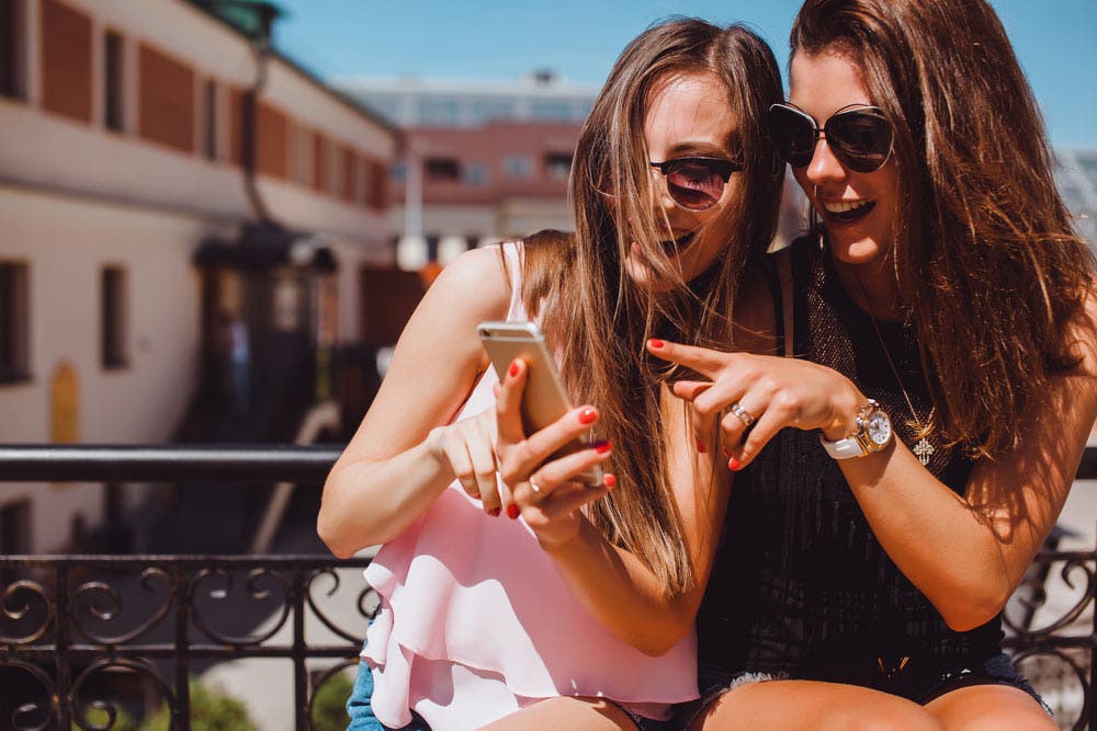 Women using iPhone on the street