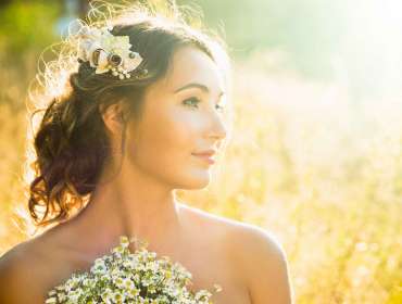 Portrait of a lady holding a bouquet of flowers outdoors