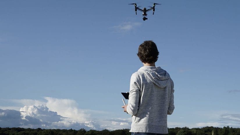 man navigating flying drone
