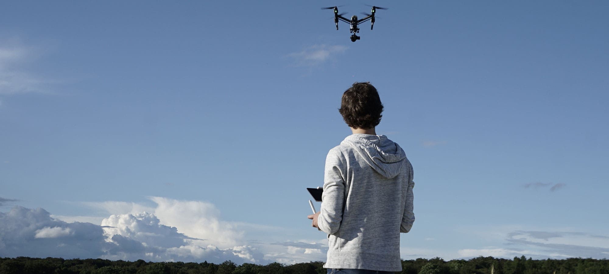 man navigating flying drone