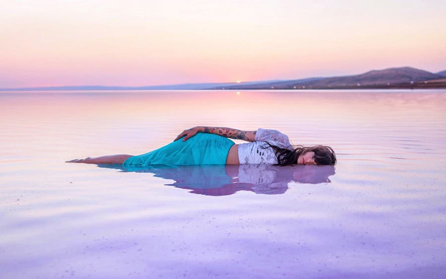 model lying in a water in turkey travel photography