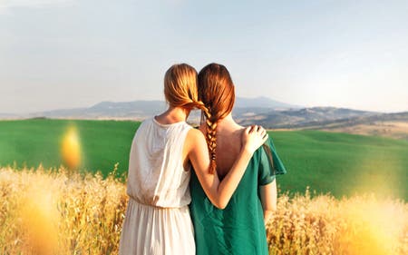 two sisters with hair braided together in tuscany travel photography