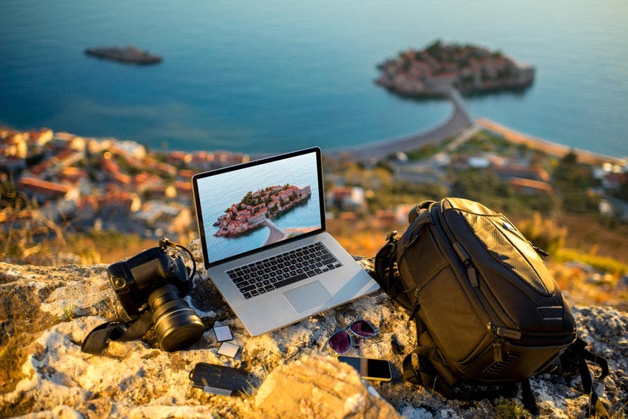 Camera accessories of an adventure photographer laid on mountain top