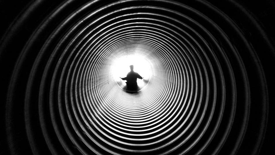 Silhouette of man sub-framed with tunnel camera view