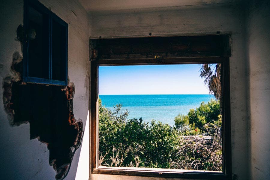Window in an old house showing a view of the ocean sub-framing technique