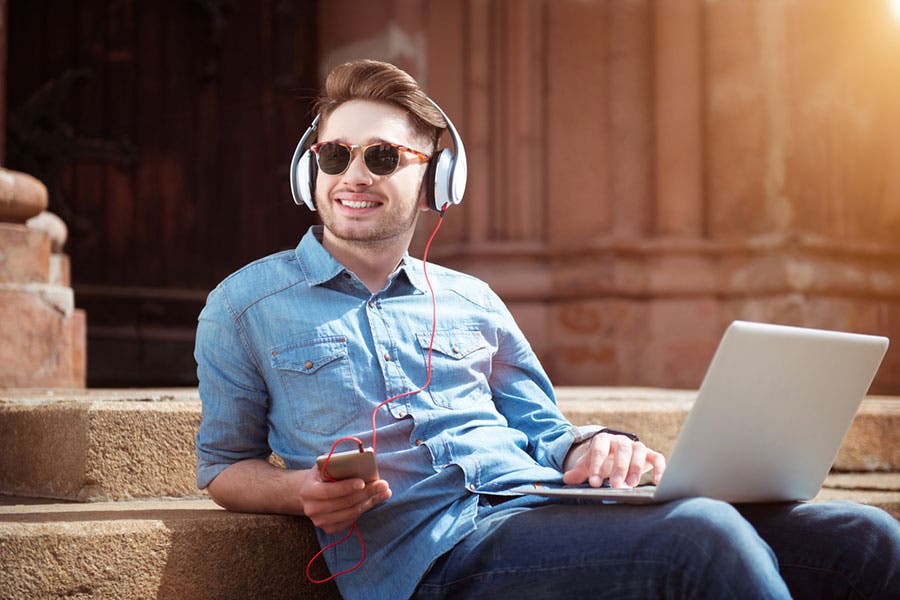 man wearing headphones while listening to music