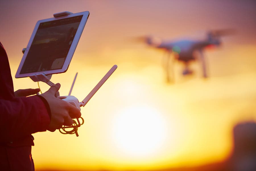 Man flying drone with remote controller