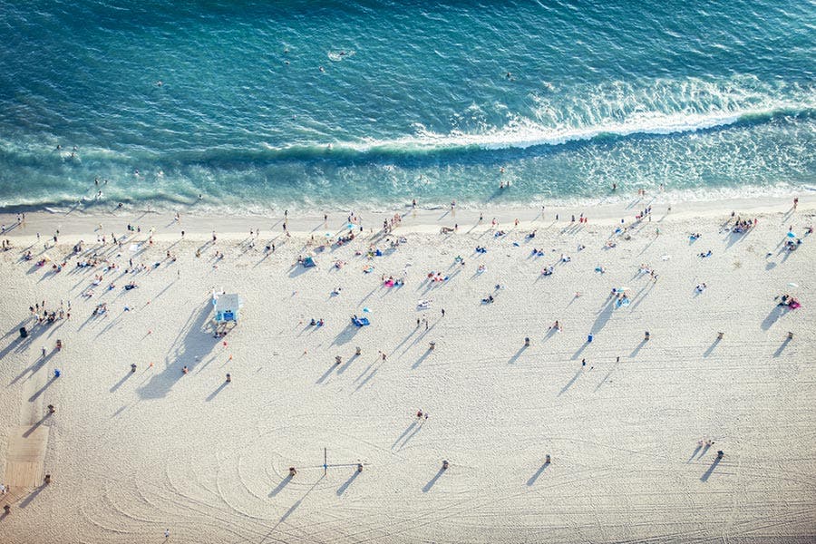 aerial view of beach shoreline and people
