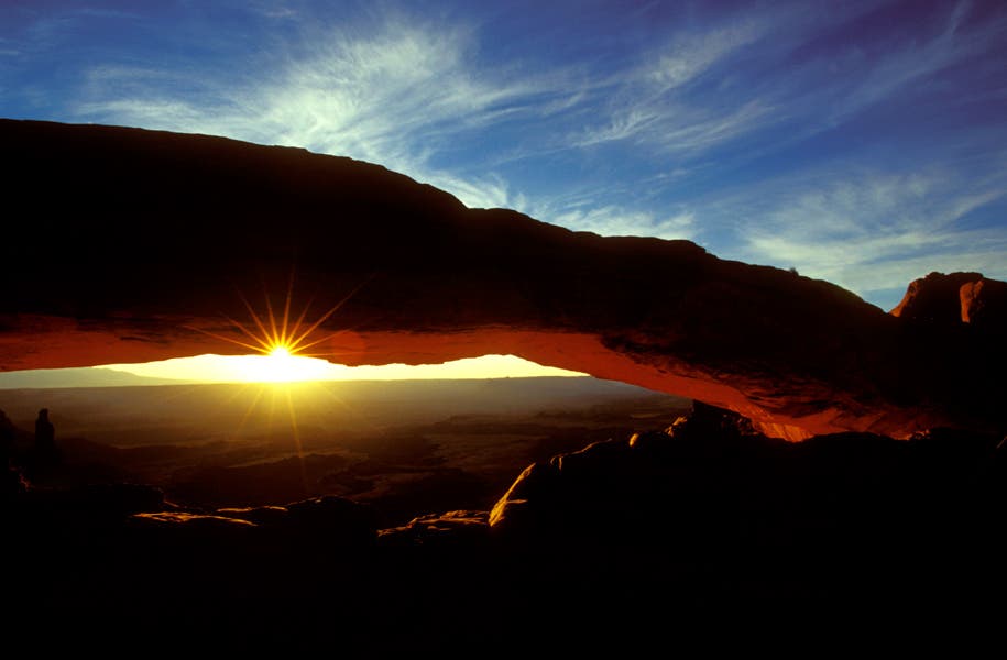 mesa arch rock formation during sunrise