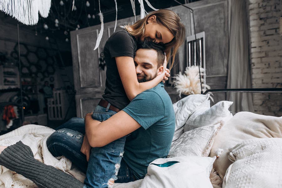 loving couple hugging on a bed portrait photography